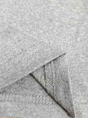 Close-up of a grey rib-knit fabric showcasing the seam and texture for women's trousers.