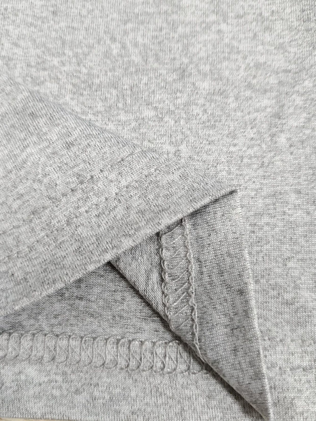 Close-up of a grey rib-knit fabric showcasing the seam and texture for women's trousers.